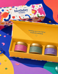 “Birthday Wishes” luxury candle gift set featuring three scented gold candle tins presented in a colourful premium magnetic keepsake box, perfect as a birthday gift for her.