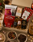 Luxury Christmas gift hamper in a premium magnetic gift box featuring Christmas pudding popcorn, festive munch mix, Wagyu beef and honey mustard crisps, artisan dark chocolate, Candy Lane flapjack, The Famous Grouse whisky and Jack Daniel's whiskey.