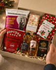 Luxury Christmas gift hamper in a premium magnetic gift box featuring Christmas pudding popcorn, festive munch mix, Wagyu beef and honey mustard crisps, artisan dark chocolate, Candy Lane flapjack, The Famous Grouse whisky and Jack Daniel's whiskey.