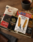 Luxury letterbox gift hamper for him featuring Jack Daniel's whiskey, artisan chocolate, English breakfast tea, sweet chilli peanuts and shortbread presented in a premium Hallby gift box.