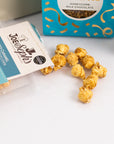aesthetic shot of the salted caramel popcorn spilt out the pack from the Thank you treat box