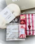 Collection of self-care products including eye masks and gummies on a white surface.