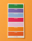 A weekly planner sticker sheet from Edit Five featuring colored blocks for Monday through Sunday with white text labels, displayed on a solid orange background. Colourful Monday–Sunday weekly planner notepad with a bright rainbow layout, daily planning sections and 50 tear-off sheets for appointments, meal plans, work tasks and family schedules.