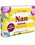 A packaged soap bar box labeled 'EDIT FIVE Nan SOAP BAR' with 'Pink Grapefruit' on a purple badge. The box has a yellow-and-white striped design with watercolor floral accents in purple, green, and yellow, photographed on a clean white background. Natural pink grapefruit soap bar handmade in England—a thoughtful gift for Grandma or Nan for Mother’s Day, birthdays, Christmas, thank-yous or simply to show she is loved.