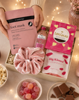 Luxury pink letterbox gift hamper featuring Gordon's Pink Gin, strawberry lip balm, pink velvet scrunchie, hydrating foot mask, salted caramel milk chocolate and an 'Ask Mummy and Daddy – Big Kisses' keepsake in a premium Hallby gift box.