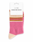 A pair of pink and beige ribbed socks with brown stripes, packaged on a white card labeled 'EDIT FIVE SIGNATURE SOCKS' against a white background. Soft pink, peach and orange striped socks for women with a durable, flexible fit, ideal for lounging at home, styling with trainers, casual outfits and colourful sock gifts.