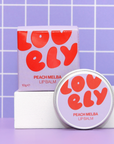 LOVELY Peach Melba lip balm with packaging on a purple tiled background