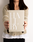 Someone holding Hallby branded gift box.