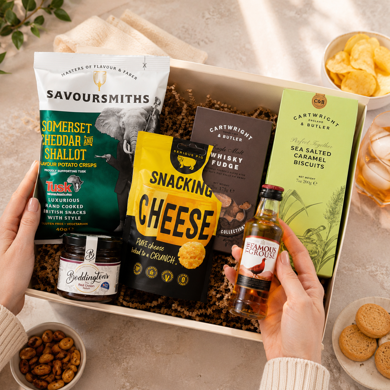 Luxury gift hamper for him presented in a magnetic gift box featuring Famous Grouse whisky, Savoursmiths cheddar and shallot crisps, snacking cheese, red onion relish, sea salted caramel biscuits and whisky fudge.