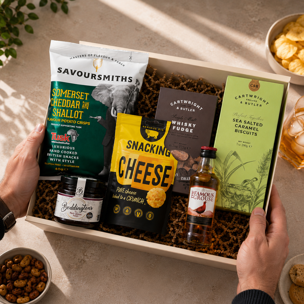 Luxury gift hamper for him presented in a magnetic gift box featuring Famous Grouse whisky, Savoursmiths cheddar and shallot crisps, snacking cheese, red onion relish, sea salted caramel biscuits and whisky fudge.