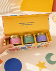 Luxury birthday gift for her featuring three scented candles in decorative gold tins, beautifully presented in a bold, colourful magnetic keepsake box designed in the UK.