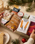 Luxury Christmas letterbox gift hamper featuring gingerbread popcorn, Candy Lane flapjack, buttery shortbread, peppermint tea, cinnamon toast blonde chocolate, artisan sourdough crackers and Christmas chutney presented in a premium Hallby gift box.