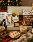 Luxury Christmas letterbox gift hamper featuring Baileys Irish Cream, English Breakfast tea, cinnamon roll popcorn, salted caramel chocolate, zesty lime and chilli peanut and cashew mix, and all-butter shortbread presented in a premium Hallby gift box.