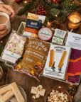 Luxury Christmas letterbox gift hamper featuring gingerbread popcorn, Candy Lane flapjack, buttery shortbread, peppermint tea, cinnamon toast blonde chocolate, artisan sourdough crackers and Christmas chutney presented in a premium Hallby gift box.