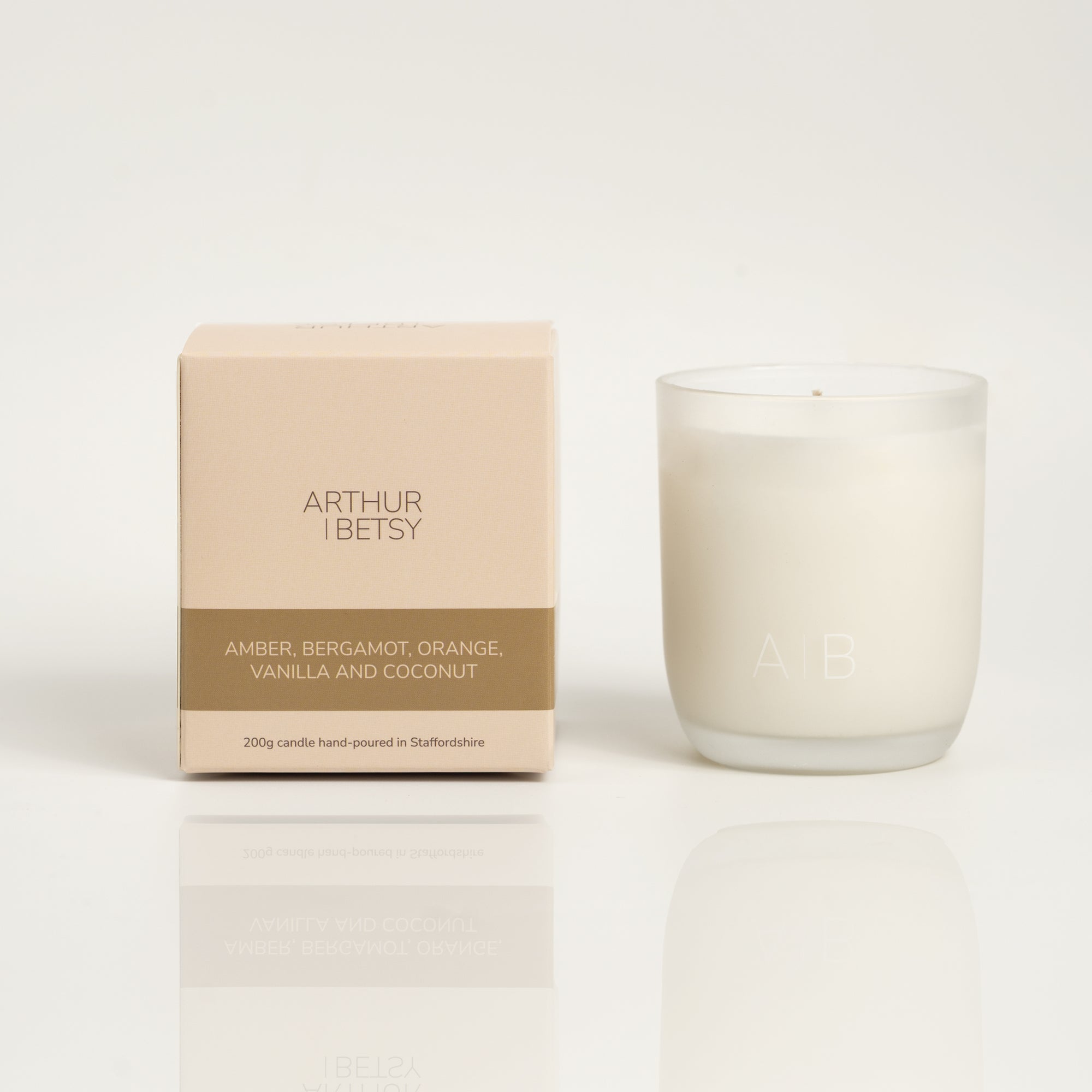 200g candle featuring a blend of warm amber, refreshing bergamot, tangy orange, sweet vanilla and creamy coconut with branded box