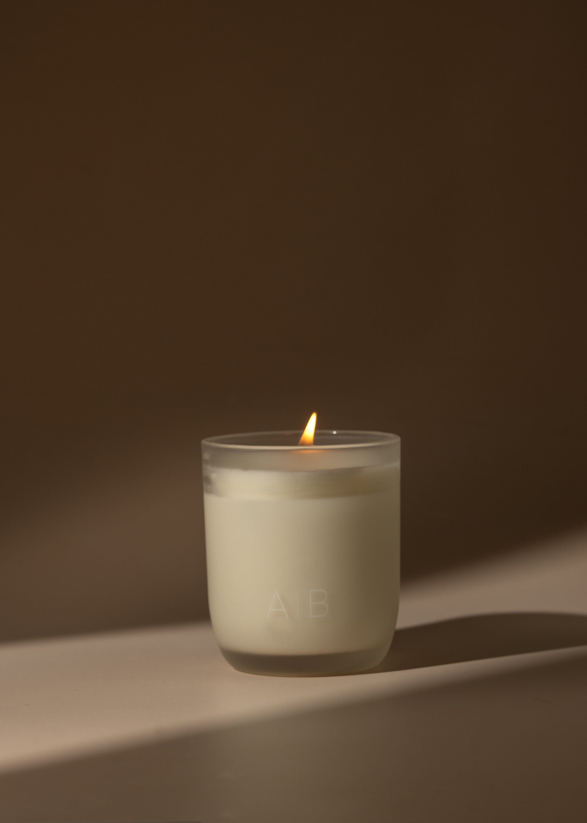 A lit assionfruit, pineapple, grapefruit, and peach with our Arthur Betsy 200g candle