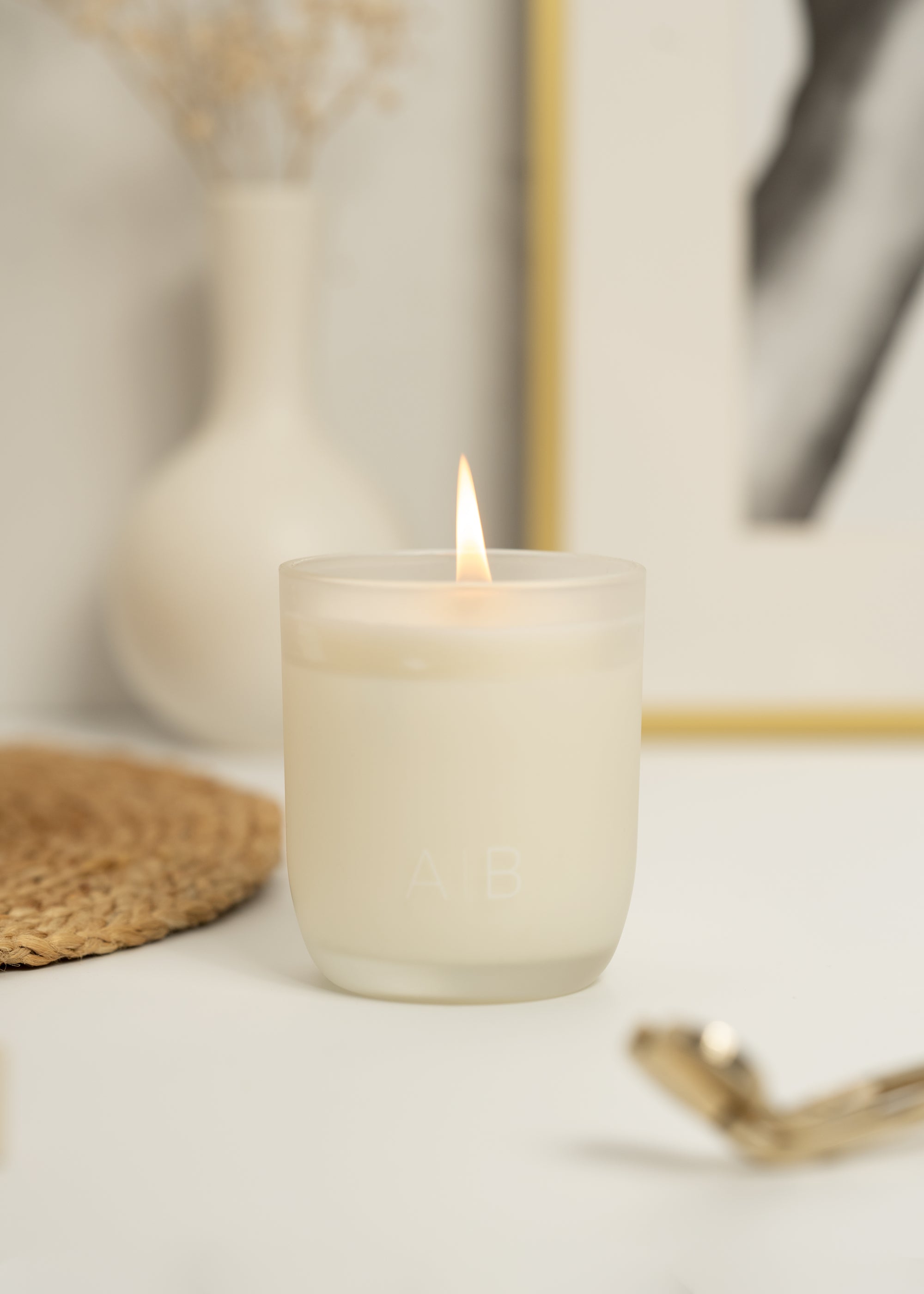 A lit assionfruit, pineapple, grapefruit, and peach with our Arthur Betsy 200g candle