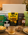 Luxury gift hamper for him presented in a magnetic gift box featuring Famous Grouse whisky, Savoursmiths cheddar and shallot crisps, snacking cheese, red onion relish, sea salted caramel biscuits and whisky fudge.