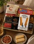 Luxury letterbox gift hamper for him featuring Jack Daniel's whiskey, artisan chocolate, English breakfast tea, sweet chilli peanuts and shortbread presented in a premium Hallby gift box.