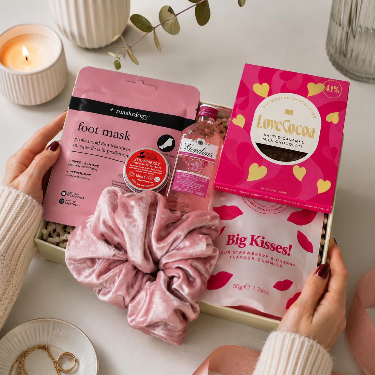 Luxury pink letterbox gift hamper featuring Gordon's Pink Gin, strawberry lip balm, pink velvet scrunchie, hydrating foot mask, salted caramel milk chocolate and an 'Ask Mummy and Daddy – Big Kisses' keepsake in a premium Hallby gift box.