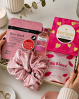 Luxury pink letterbox gift hamper featuring Gordon's Pink Gin, strawberry lip balm, pink velvet scrunchie, hydrating foot mask, salted caramel milk chocolate and an 'Ask Mummy and Daddy – Big Kisses' keepsake in a premium Hallby gift box.