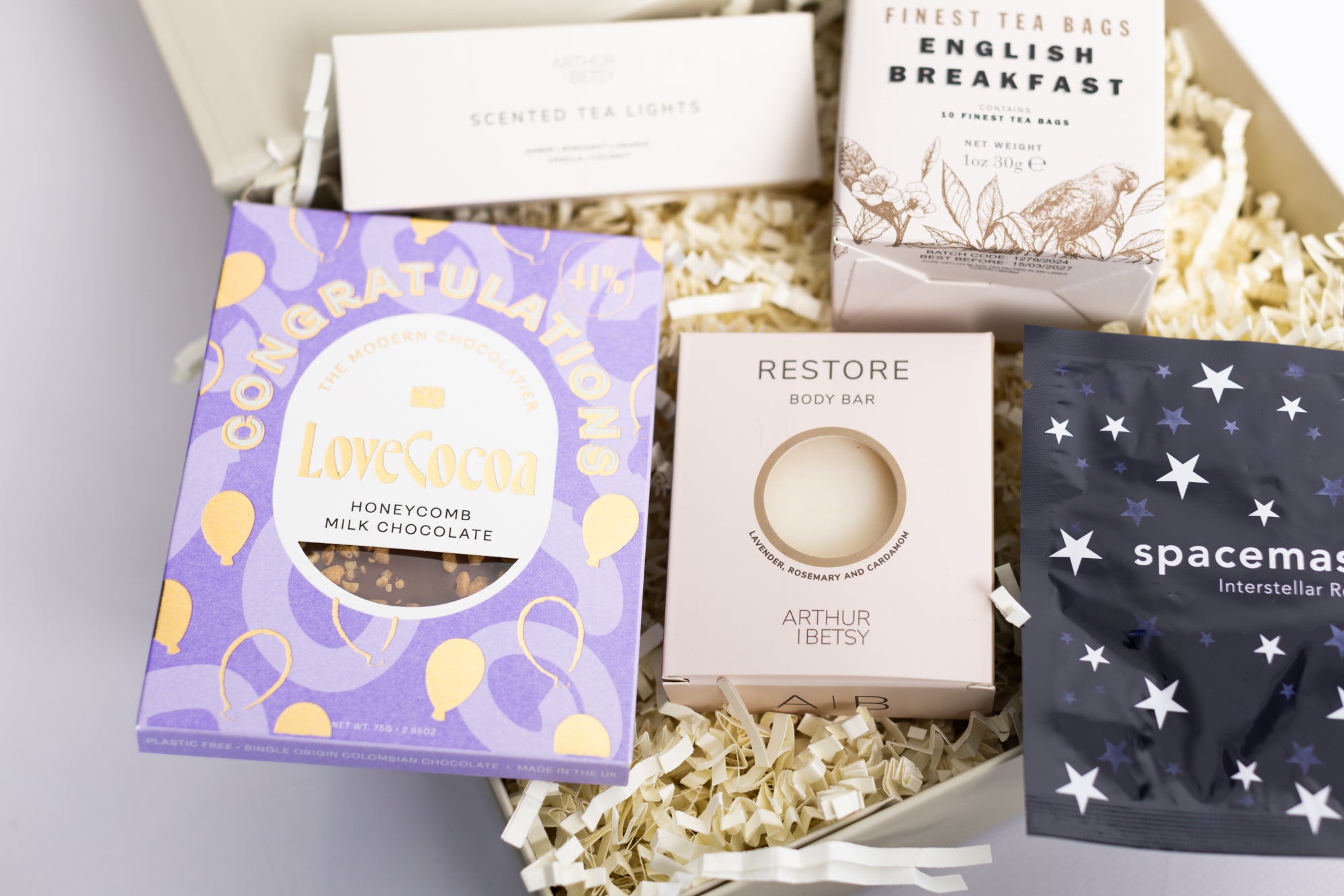 Congratulations gift box with Love cocoa congratulations chocolate slab, 3x scented tea lights set, English breakfast tea bags, restore soap bar, space self-heating eye mask. Perfect for mum, dad, sister, friend, employee, client, daughter, son.