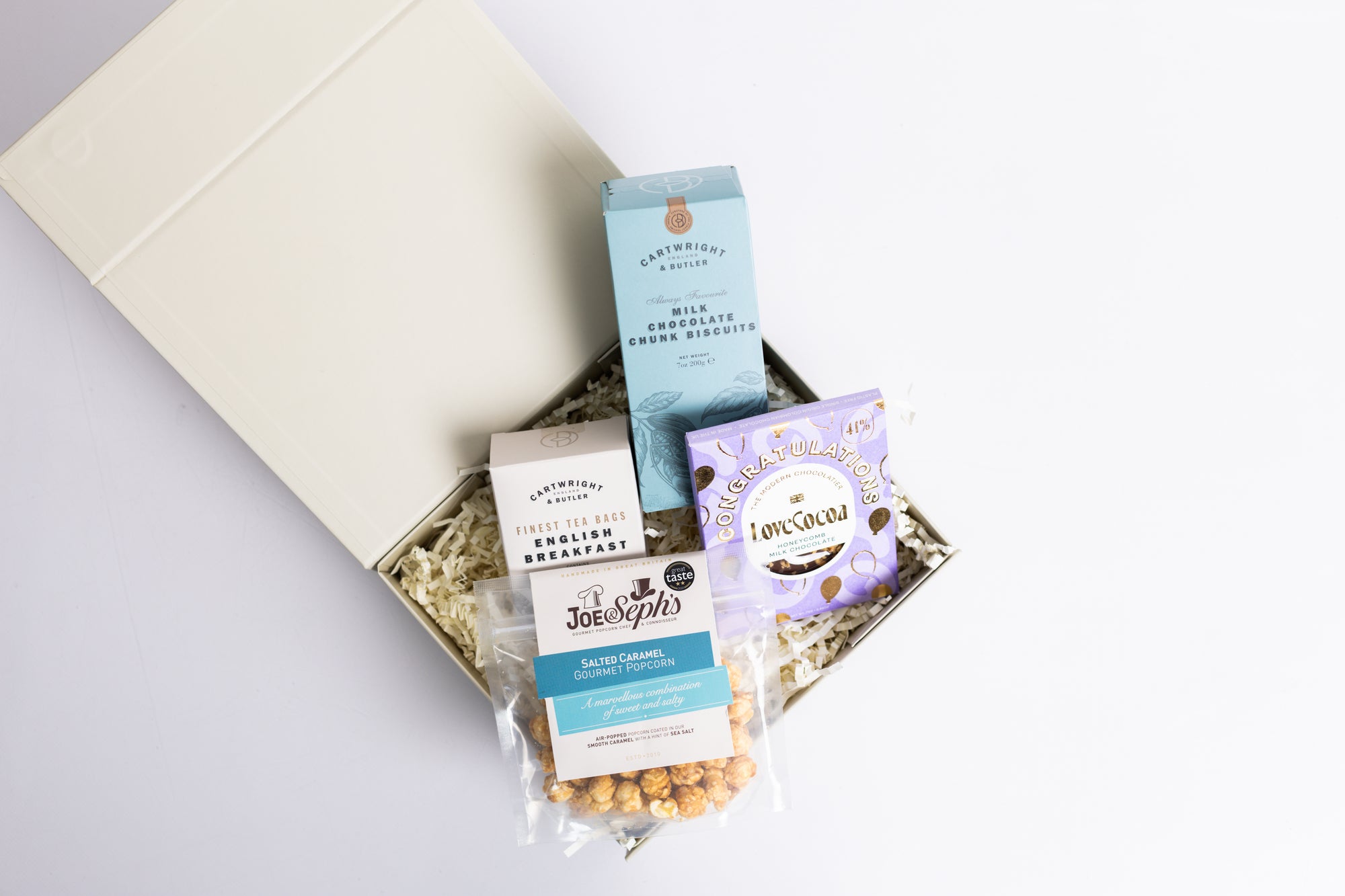 Congratulations Hamper with Milk chocolate chunk biscuits, Love cocoa congratulations chocolate slab, salted caramel popcorn and English breakfast tea bags. Perfect for mum, dad, sister, friend, employee, client, daughter, son.