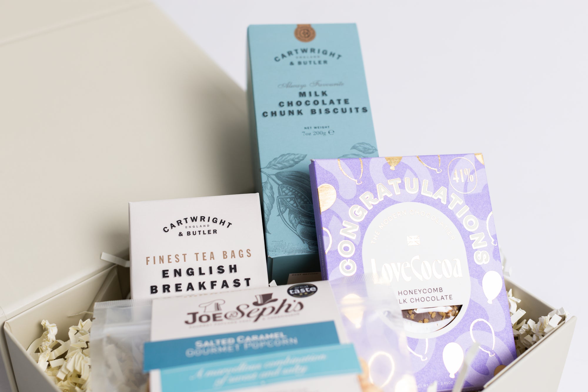 Congratulations Hamper with Milk chocolate chunk biscuits, Love cocoa congratulations chocolate slab, salted caramel popcorn and English breakfast tea bags. Perfect for mum, dad, sister, friend, employee, client, daughter, son.