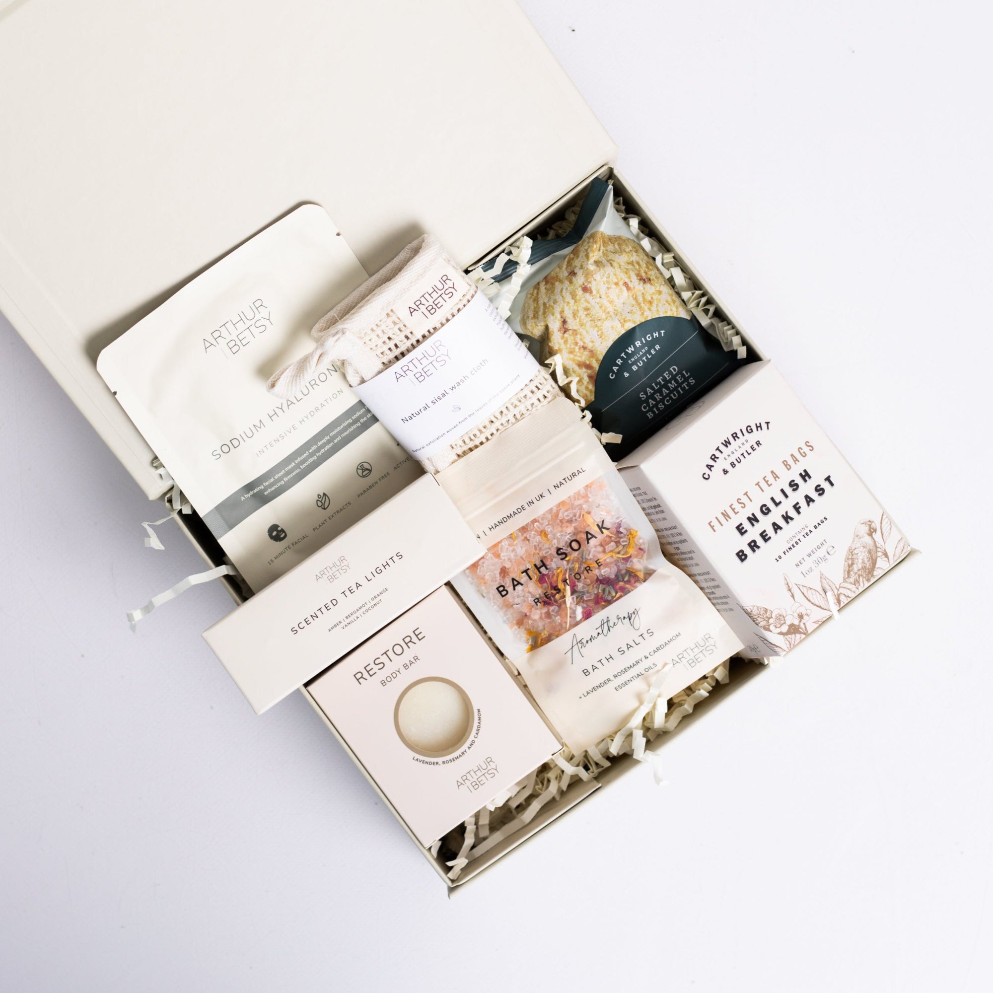 Head to toe spa box with sheet mask, natural sisal wash cloth, salted caramel biscuits, 3x scented tea lights, restore bath soak, English breakfast tea bags Perfect for thank you gifts, Christmas gifts, birthday gifts, congratulations gifts, client gifts, employee gifts or just because gifts.