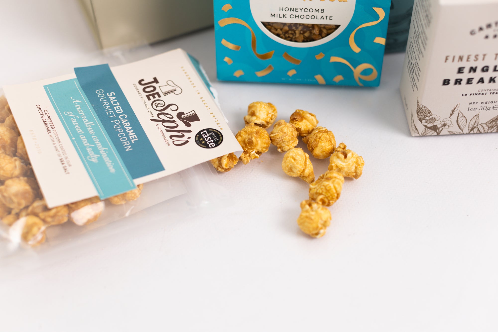 aesthetic shot of the salted caramel popcorn spilt out the pack from the Thank you treat box