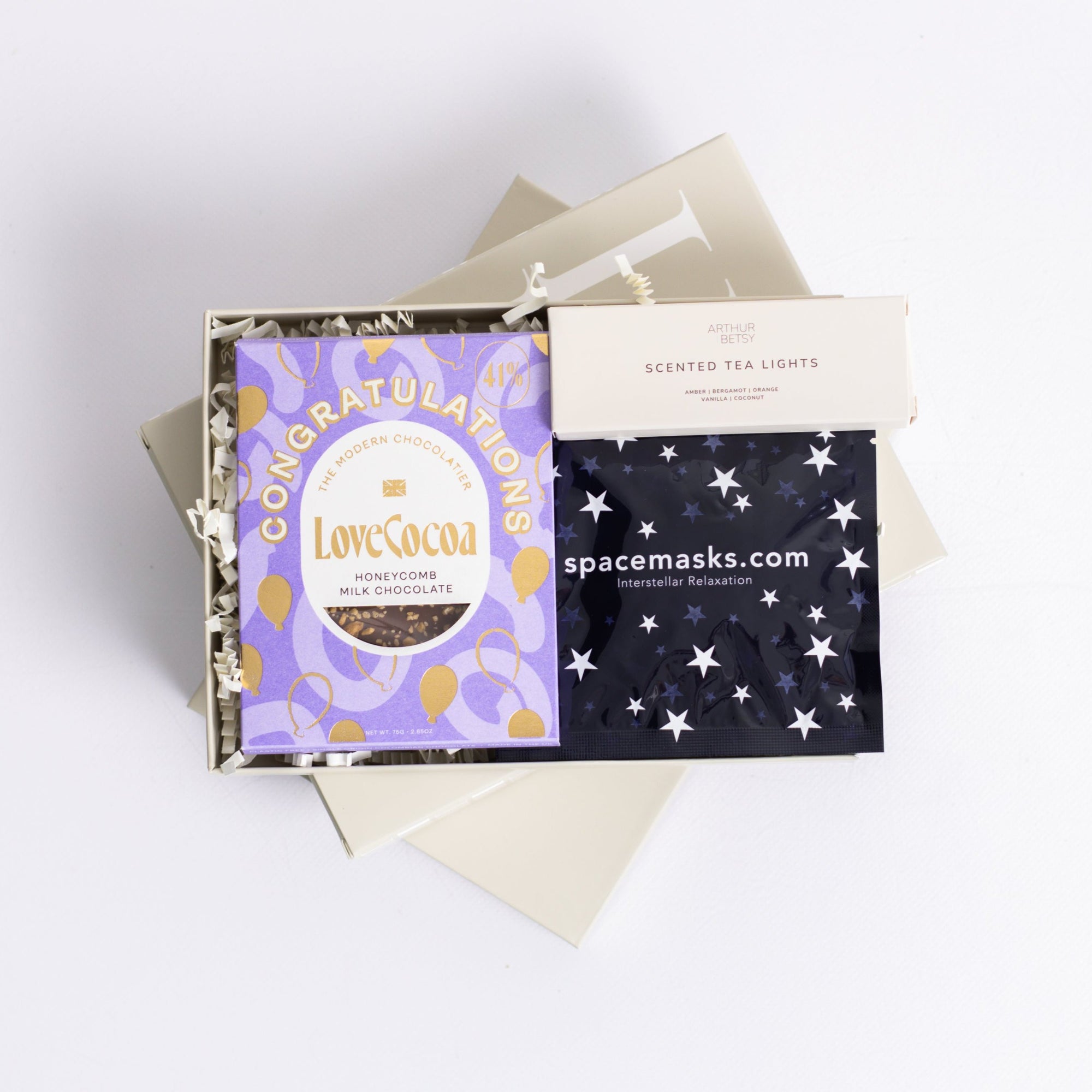 Well done you, congratulations gift box with Love Cocoa Congratulations chocolate slab, 3x Scented tea lights set and Space self-heating eye mask. Perfect for mum, dad, sister, friend, employee, client, daughter, son.