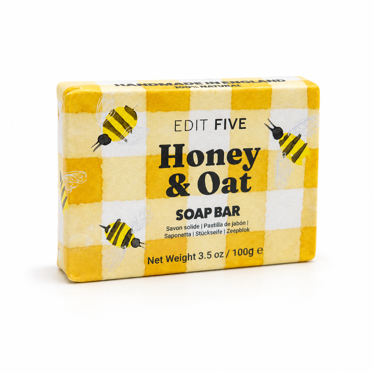 A rectangular bar of Edit Five Honey &amp; Oat soap bar in a yellow and white checkered box with illustrations of bees, photographed on a clean white background. Gift-ready 100g honey and oat body soap with a comforting scent and rich lather, ideal for self-care gift boxes, pamper hampers, stocking fillers and gifts for her or him.