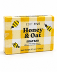 A rectangular bar of Edit Five Honey & Oat soap bar in a yellow and white checkered box with illustrations of bees, photographed on a clean white background. Gift-ready 100g honey and oat body soap with a comforting scent and rich lather, ideal for self-care gift boxes, pamper hampers, stocking fillers and gifts for her or him.