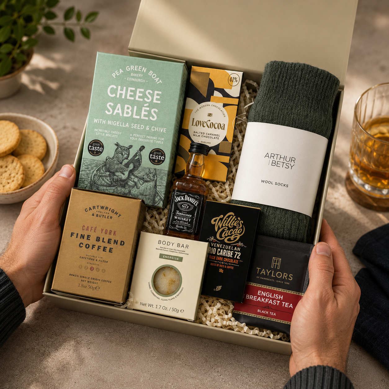 Luxury men's gift hamper in a premium magnetic gift box featuring Jack Daniel's whiskey, artisan cheese sablés, fine blend coffee, English Breakfast tea, Nordic Pine wool socks, energising body bar and Willie's Cacao dark chocolate.