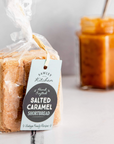 Packaged salted caramel shortbread with a tag on a white surface