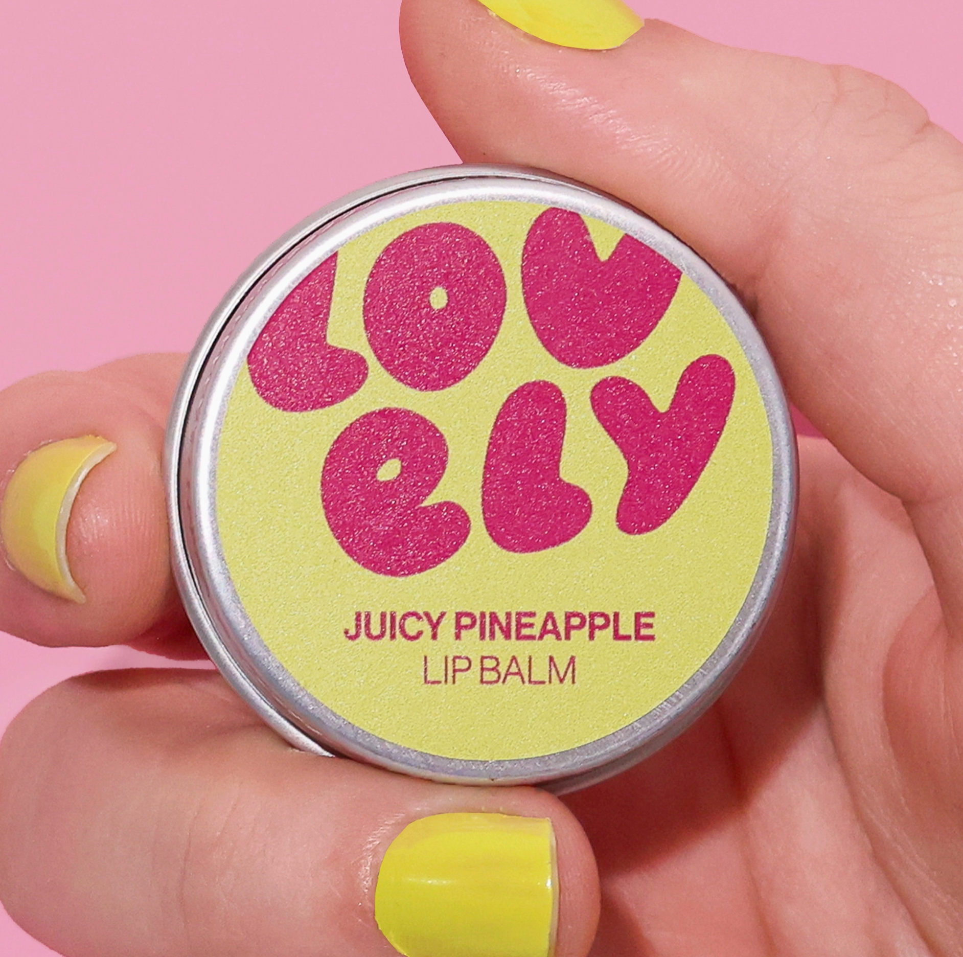 Lip balm container with 'lovely' branding held by a hand