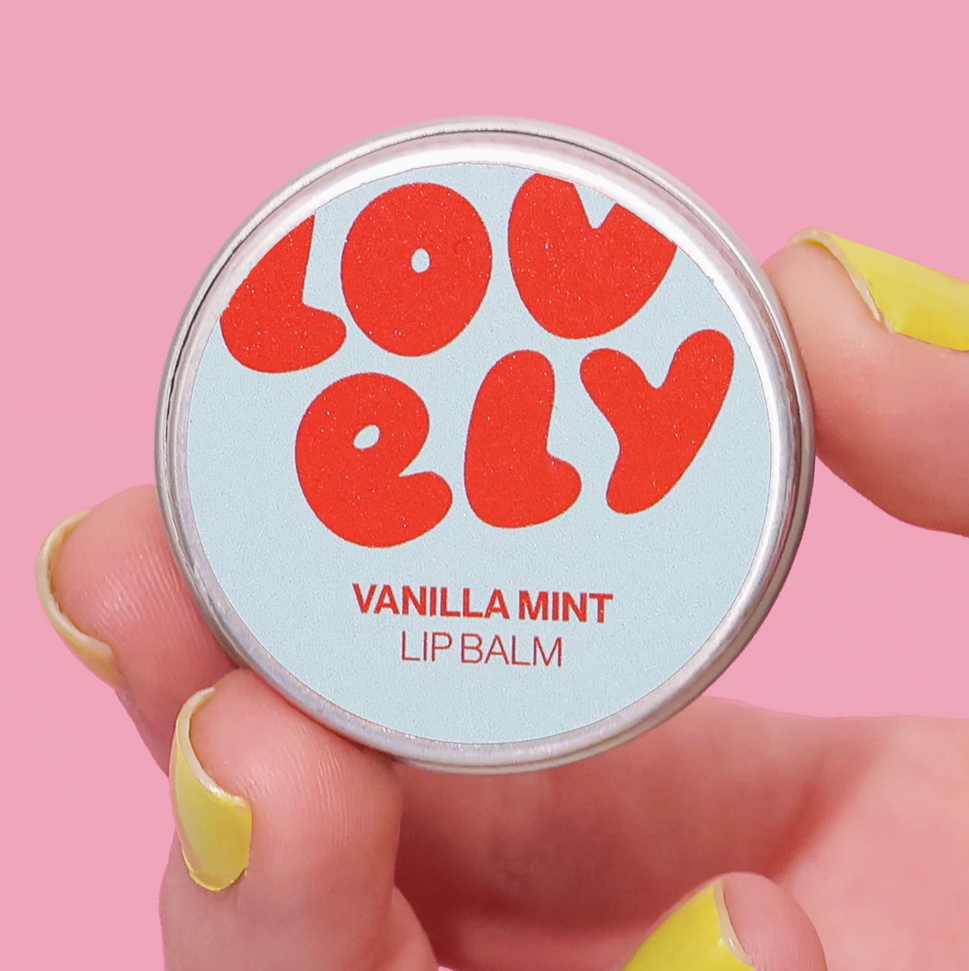 Lip balm container with 'LOVELY' branding on a pink background