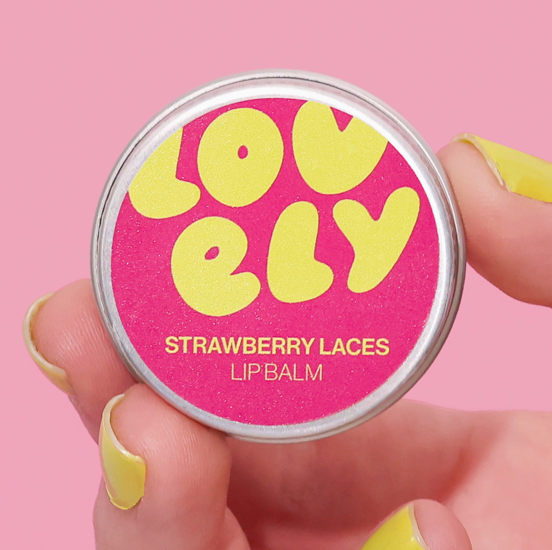 Lip balm container with 'Lovely' branding on a pink background