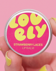 Lip balm container with 'Lovely' branding on a pink background
