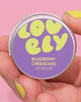 Lip balm container labeled 'Lovely Blueberry Cheesecake' 