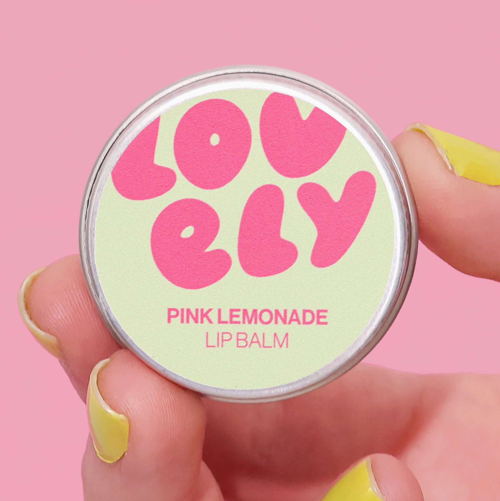 Lip balm container with 'LOVELY' branding on a pink background