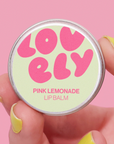 Lip balm container with 'LOVELY' branding on a pink background