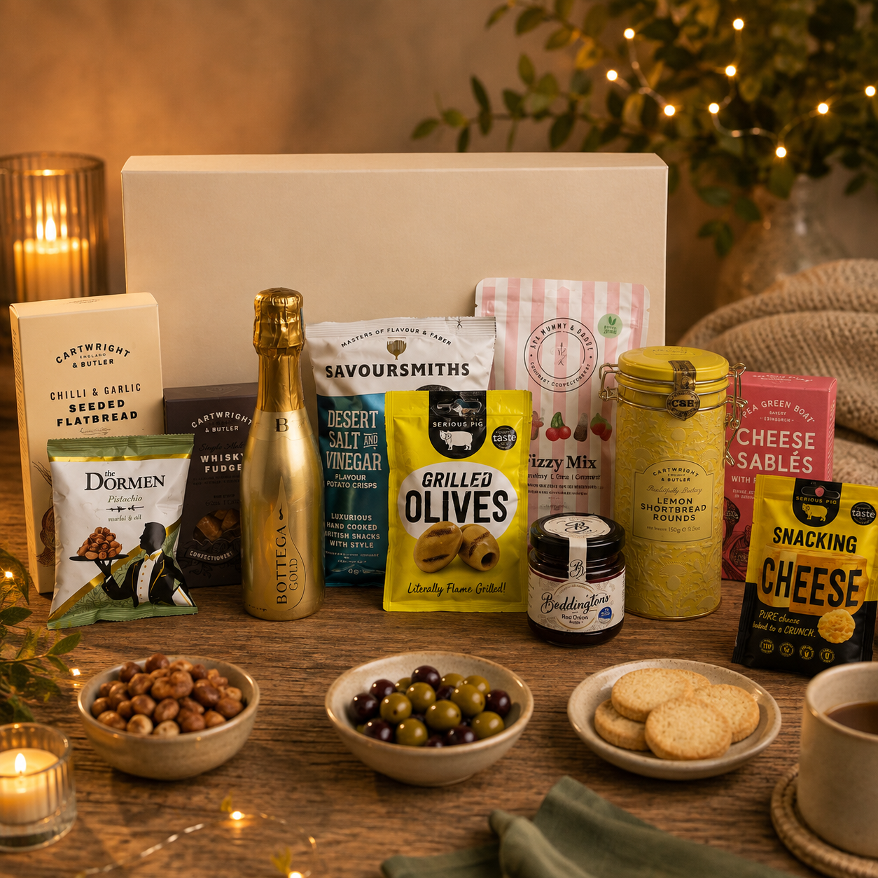 Luxury gourmet gift hamper in a large magnetic gift box featuring Bottega Prosecco, lemon shortbread tin, whisky fudge, grilled olives, pistachios, artisan cheese sablés, snacking cheese, salt and vinegar crisps, red onion relish, seeded flatbreads and fizzy mix sweets.