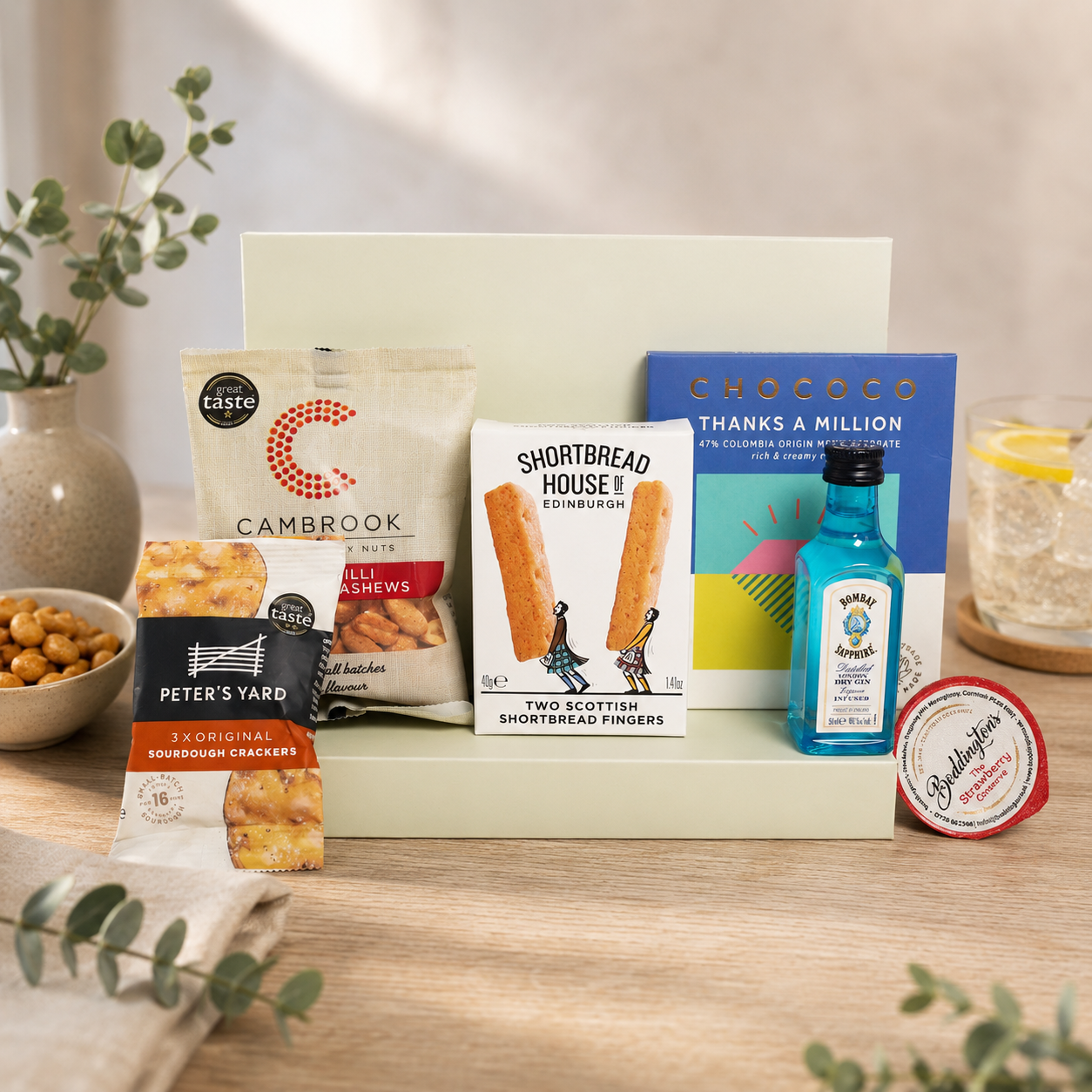 Luxury thank you letterbox gift hamper with Thanks a Million chocolate bar, Bombay Sapphire gin, sweet chilli peanuts and cashews, artisan shortbread, sourdough crackers and strawberry conserve in a premium Hallby gift box.