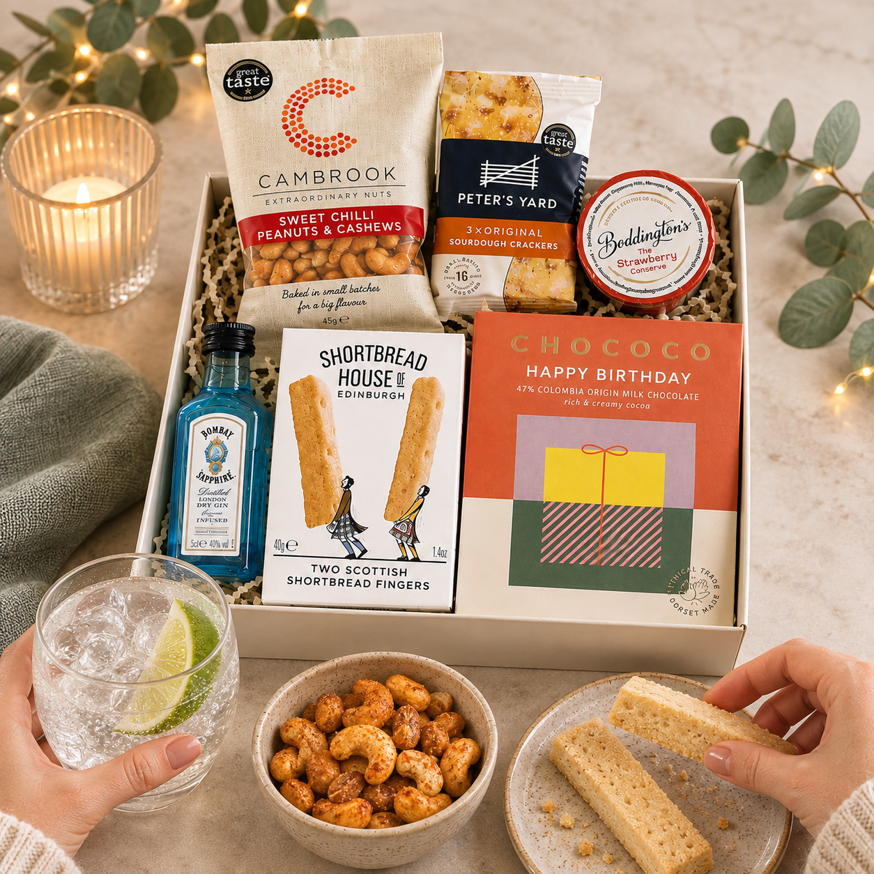 Luxury happy birthday letterbox gift hamper with birthday chocolate bar, Bombay Sapphire gin, sweet chilli peanuts and cashews, artisan shortbread, sourdough crackers and strawberry conserve in a premium Hallby gift box.