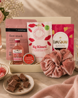 Luxury pink letterbox gift hamper featuring Gordon's Pink Gin, strawberry lip balm, pink velvet scrunchie, hydrating foot mask, salted caramel milk chocolate and an 'Ask Mummy and Daddy – Big Kisses' keepsake in a premium Hallby gift box.