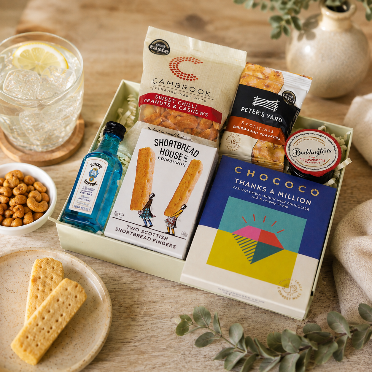 Luxury thank you letterbox gift hamper with Thanks a Million chocolate bar, Bombay Sapphire gin, sweet chilli peanuts and cashews, artisan shortbread, sourdough crackers and strawberry conserve in a premium Hallby gift box.